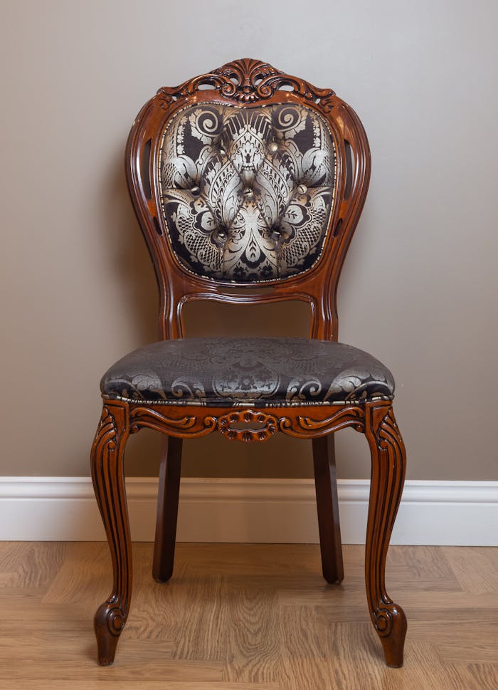 Exquisite vintage wooden chair featuring detailed ornate carvings and plush upholstery. Perfect for classic interiors.